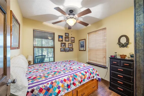 a bedroom with a bed and dresser with mirror