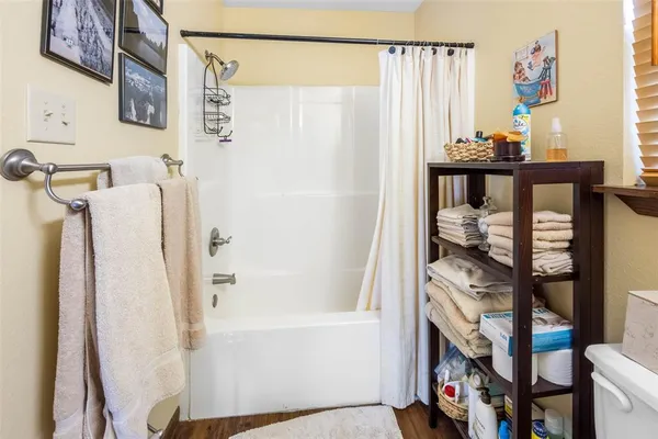 a bathroom with a bathtub and shower