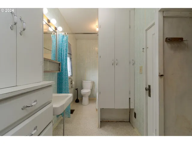a bathroom with a toilet a sink and shower