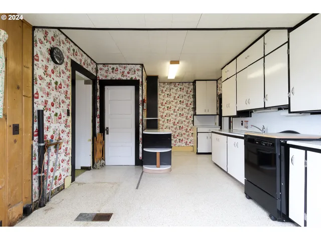a kitchen with stainless steel appliances kitchen island granite countertop a refrigerator and a stove top oven