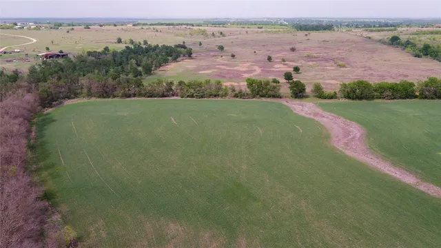 an aerial view of a houses with outdoor space and river