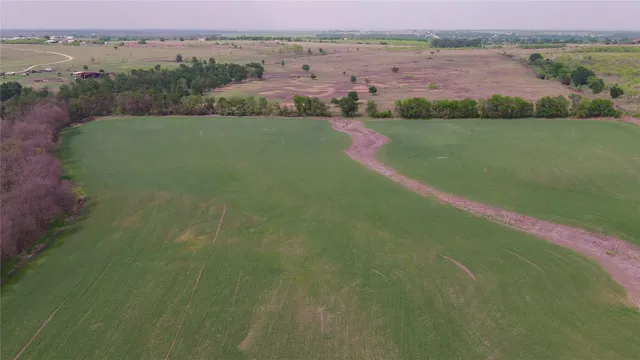an aerial view of a houses with outdoor space and garden