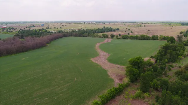 an aerial view of a golf course with parking space