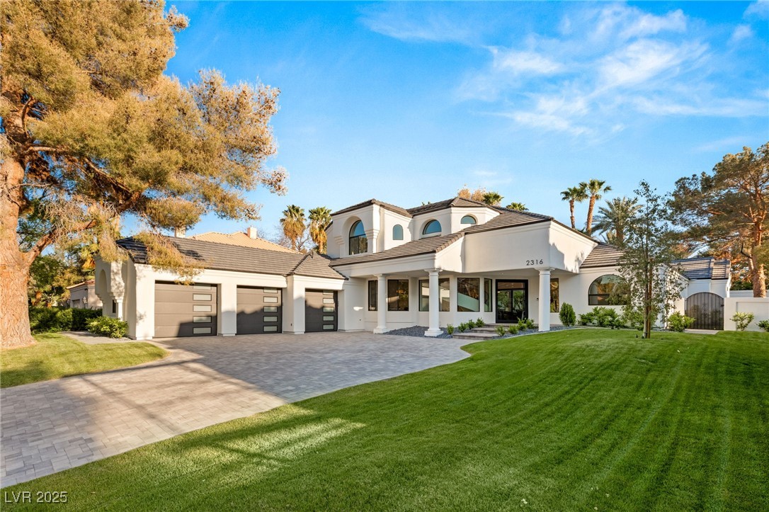2316 Prometheus Court Henderson, NV 89074 - Photo 2 of 92 View of front of home with a garage, a front yard, stucco siding, and decorative driveway