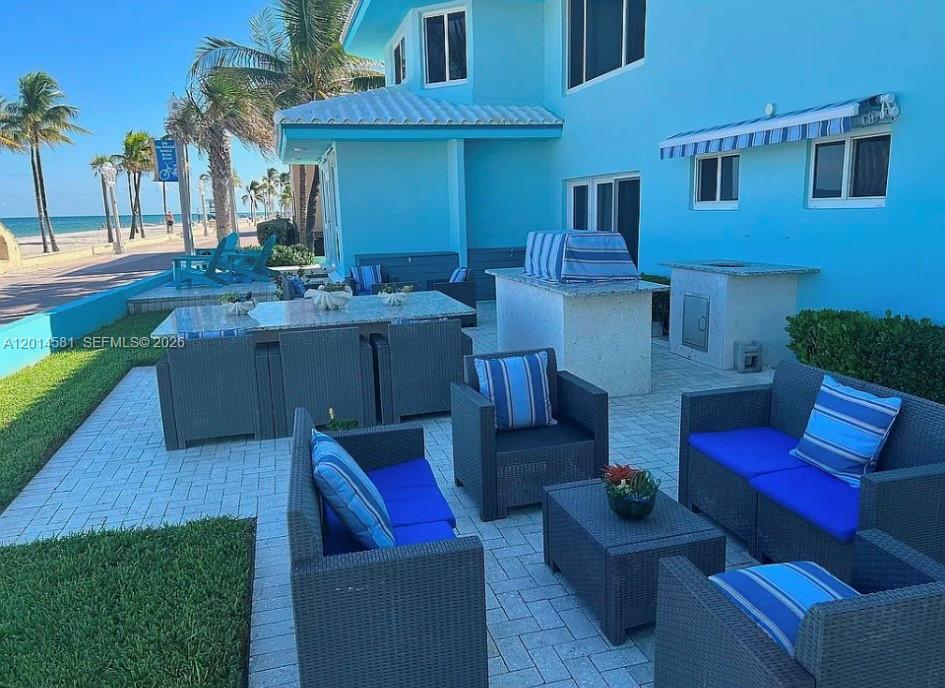 3400 North Surf Road, Unit 1 Hollywood, FL 33019 - Photo 12 of 14 a view of backyard with outdoor seating and wooden floor