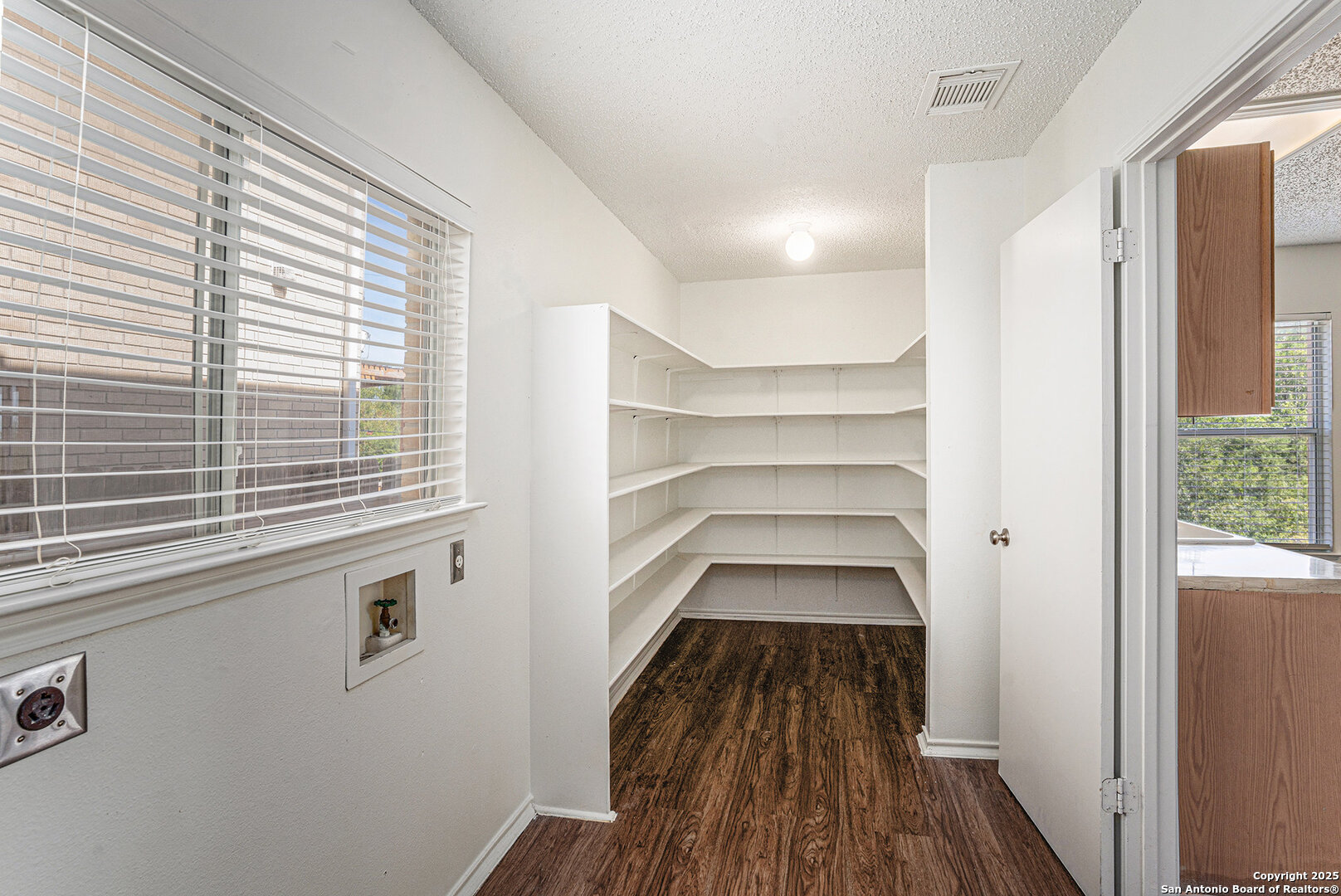 8447 Mannington Place Converse, TX 78109 - Photo 12 of 26 a view of a room with a large window and wooden floor