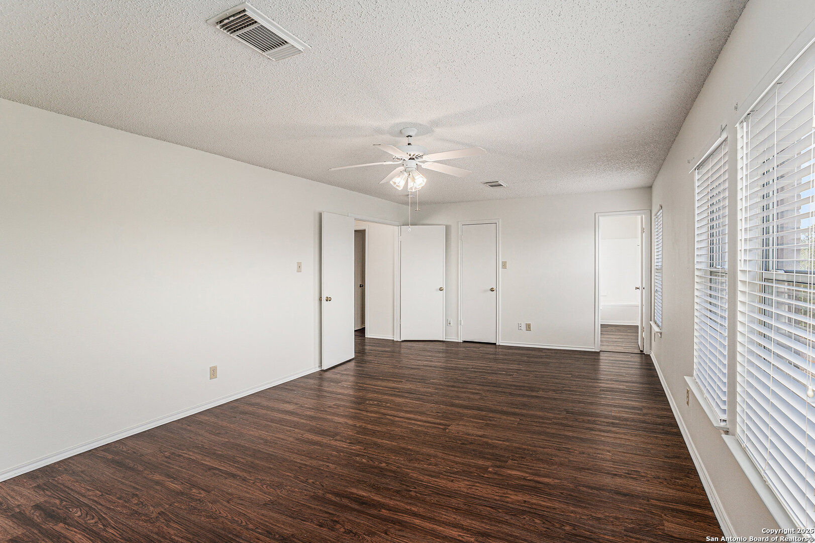 8447 Mannington Place Converse, TX 78109 - Photo 16 of 26 wooden floor in an empty room with a window