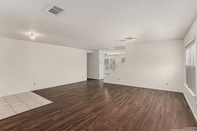 an empty room with wooden floor