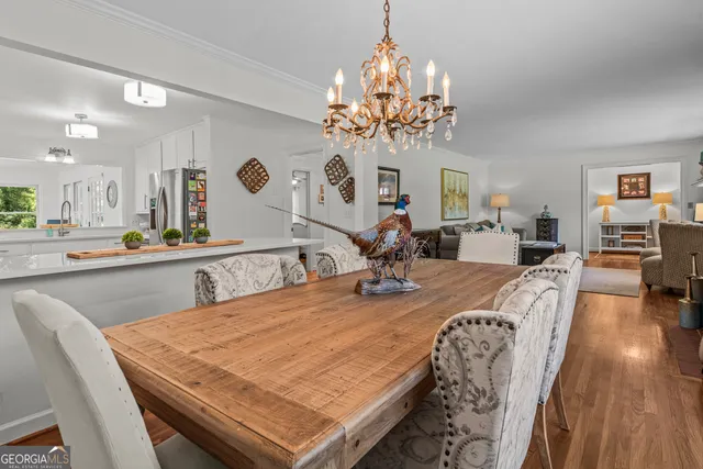 a kitchen with kitchen island granite countertop a sink cabinets and wooden floor