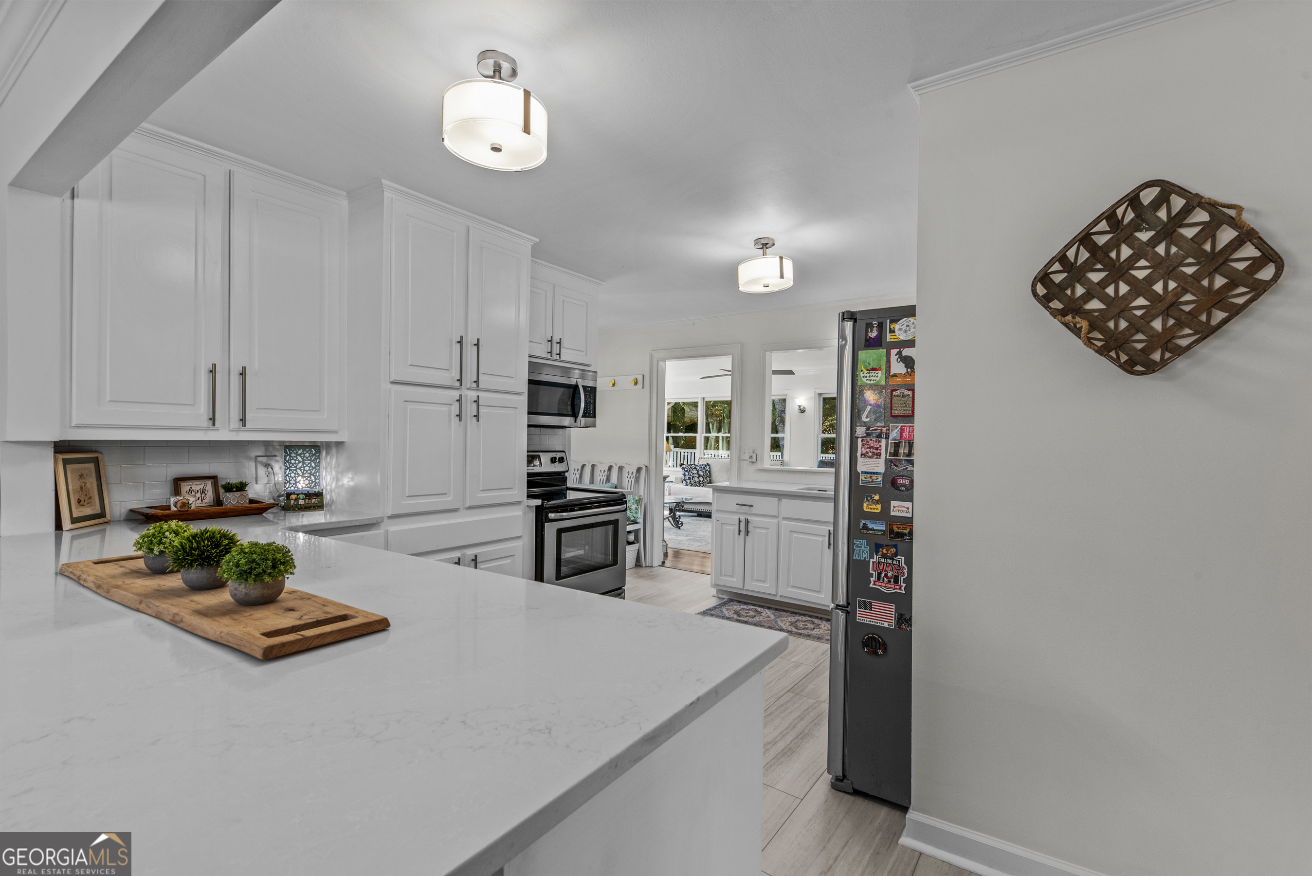 991 Old Post Road Madison, GA 30650 - Photo 13 of 61 a kitchen with stainless steel appliances a stove a refrigerator cabinets and a dining table
