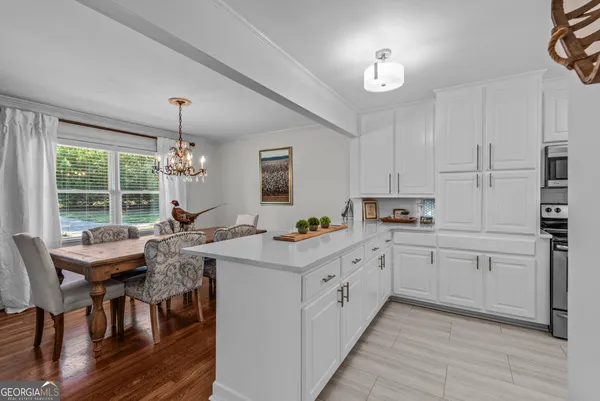 a kitchen with stainless steel appliances a stove a sink and a refrigerator