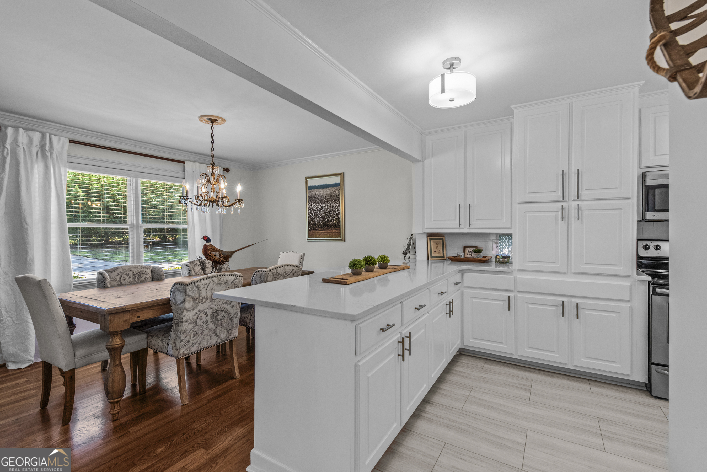 991 Old Post Road Madison, GA 30650 - Photo 14 of 61 a kitchen with kitchen island granite countertop a sink cabinets and wooden floor