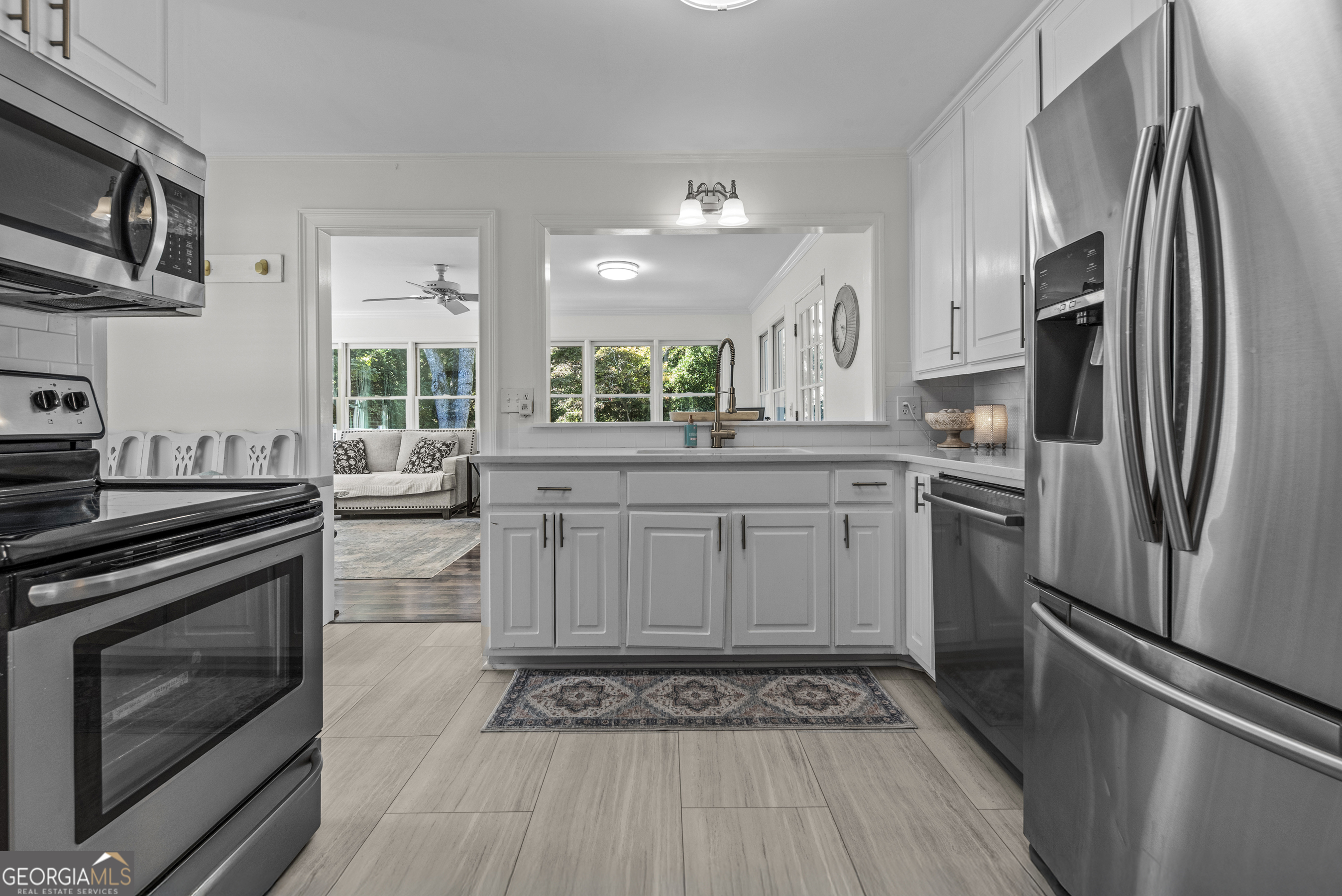 991 Old Post Road Madison, GA 30650 - Photo 17 of 61 a kitchen with stainless steel appliances a stove a sink and a refrigerator