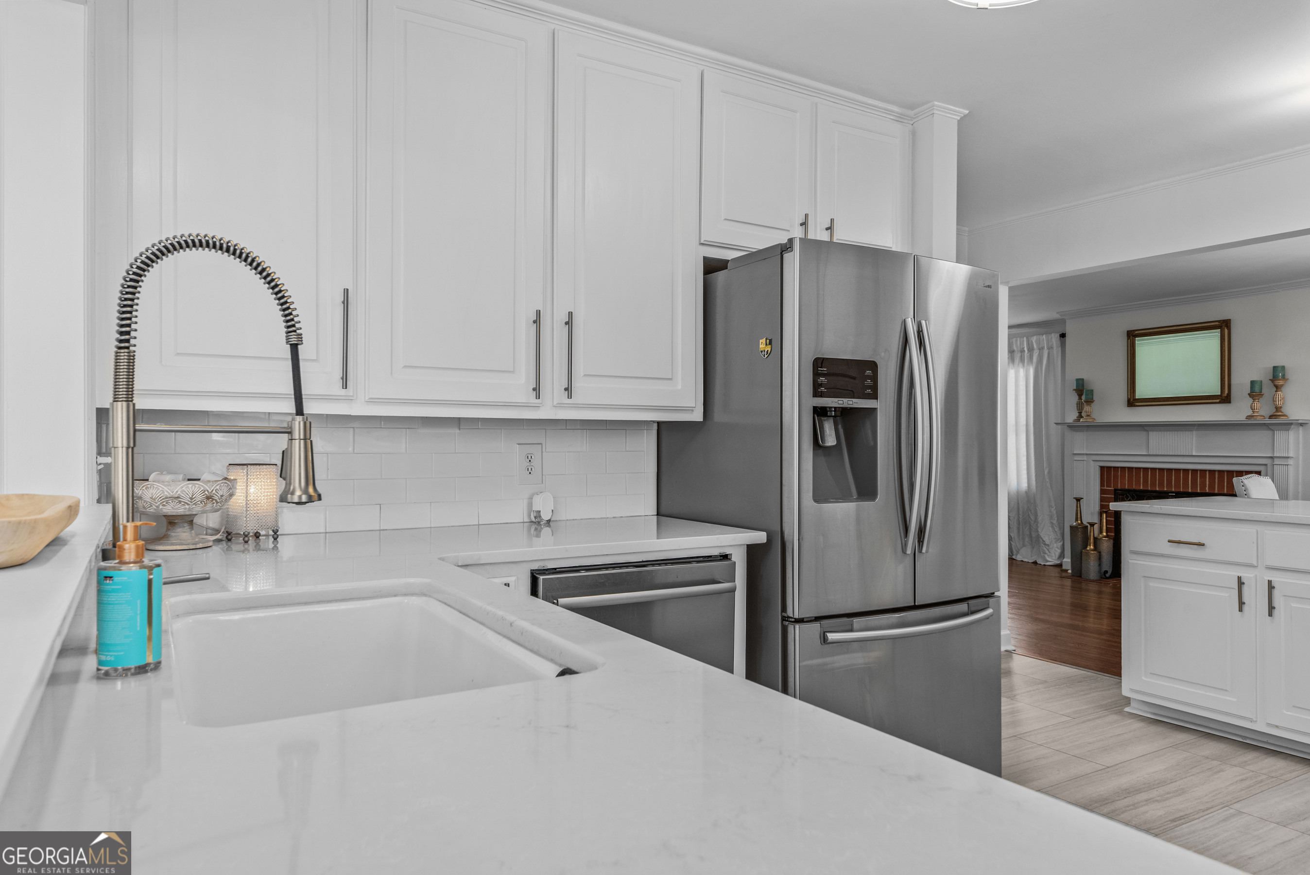 991 Old Post Road Madison, GA 30650 - Photo 21 of 61 a kitchen with stainless steel appliances kitchen island a refrigerator sink and cabinets