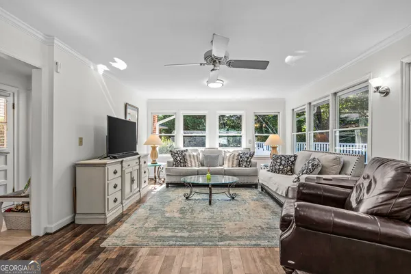 a living room with furniture and a wooden floor