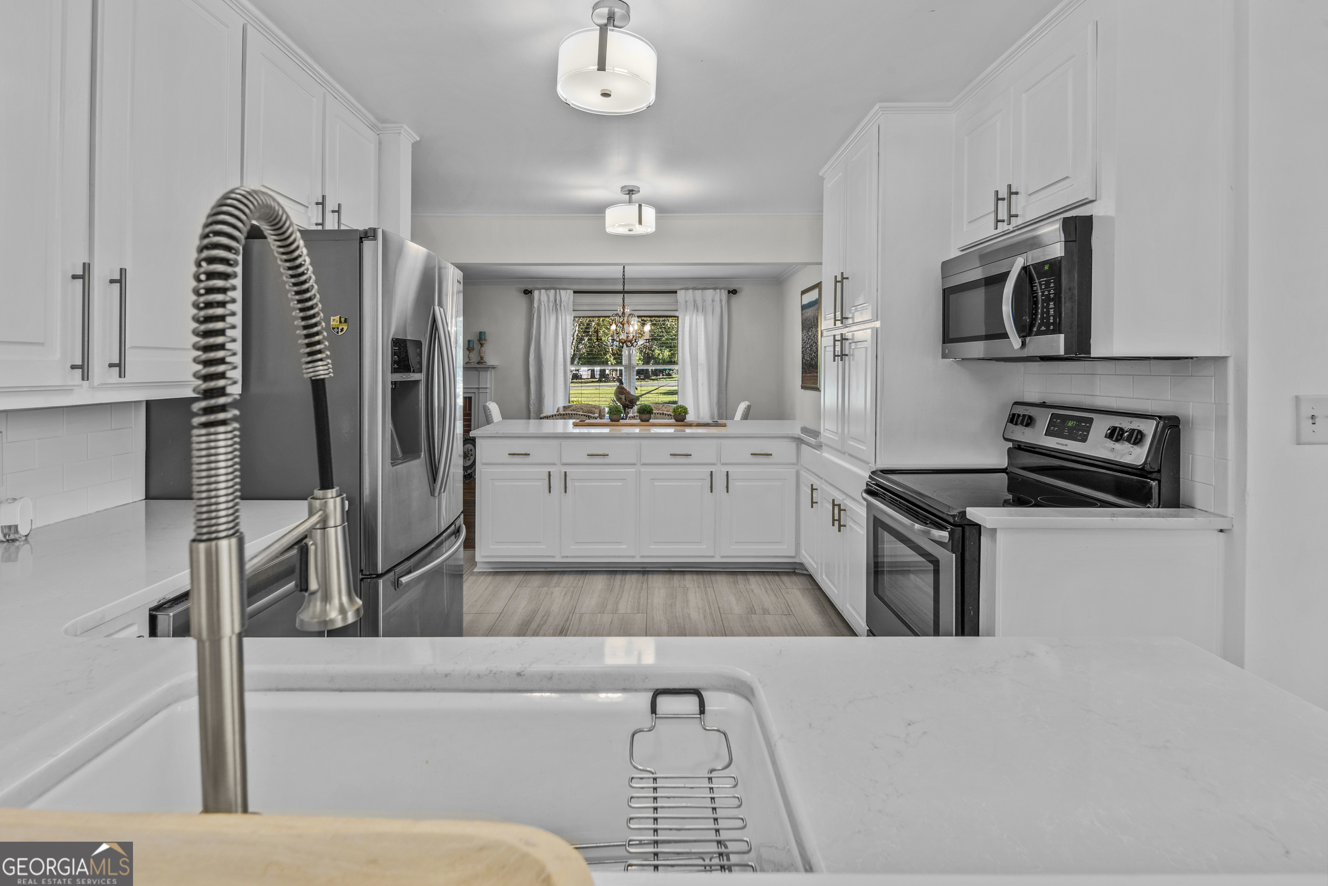 991 Old Post Road Madison, GA 30650 - Photo 25 of 61 a living room with furniture a flat screen tv and kitchen view
