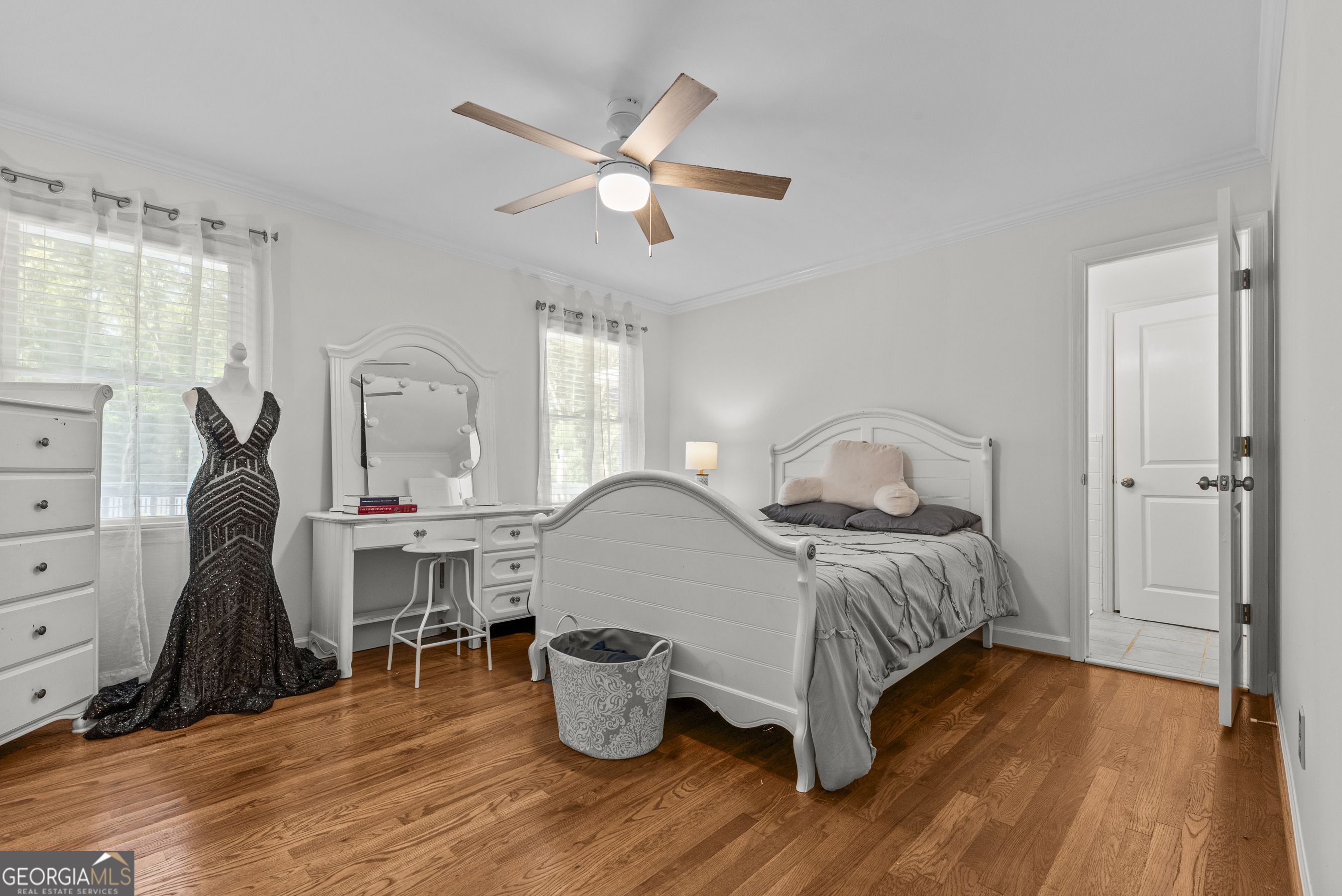 991 Old Post Road Madison, GA 30650 - Photo 28 of 61 a bedroom with a bed and wooden floor