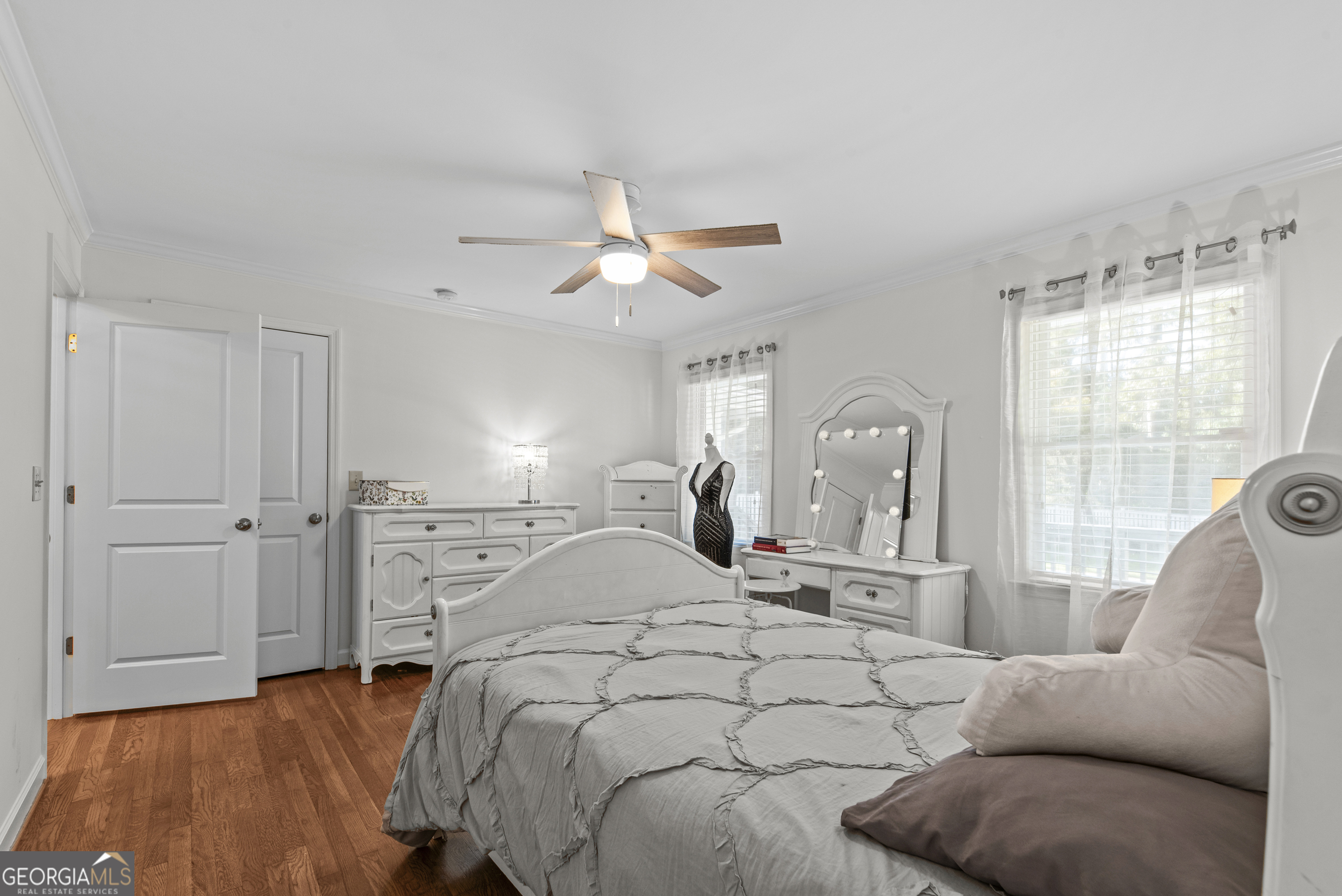 991 Old Post Road Madison, GA 30650 - Photo 29 of 61 a spacious bedroom with a bed a couch and a large window