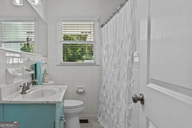 a en suite bathroom with a double vanity sink a mirror and a shower