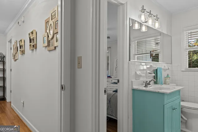 a spacious bathroom with a tub sink and mirror