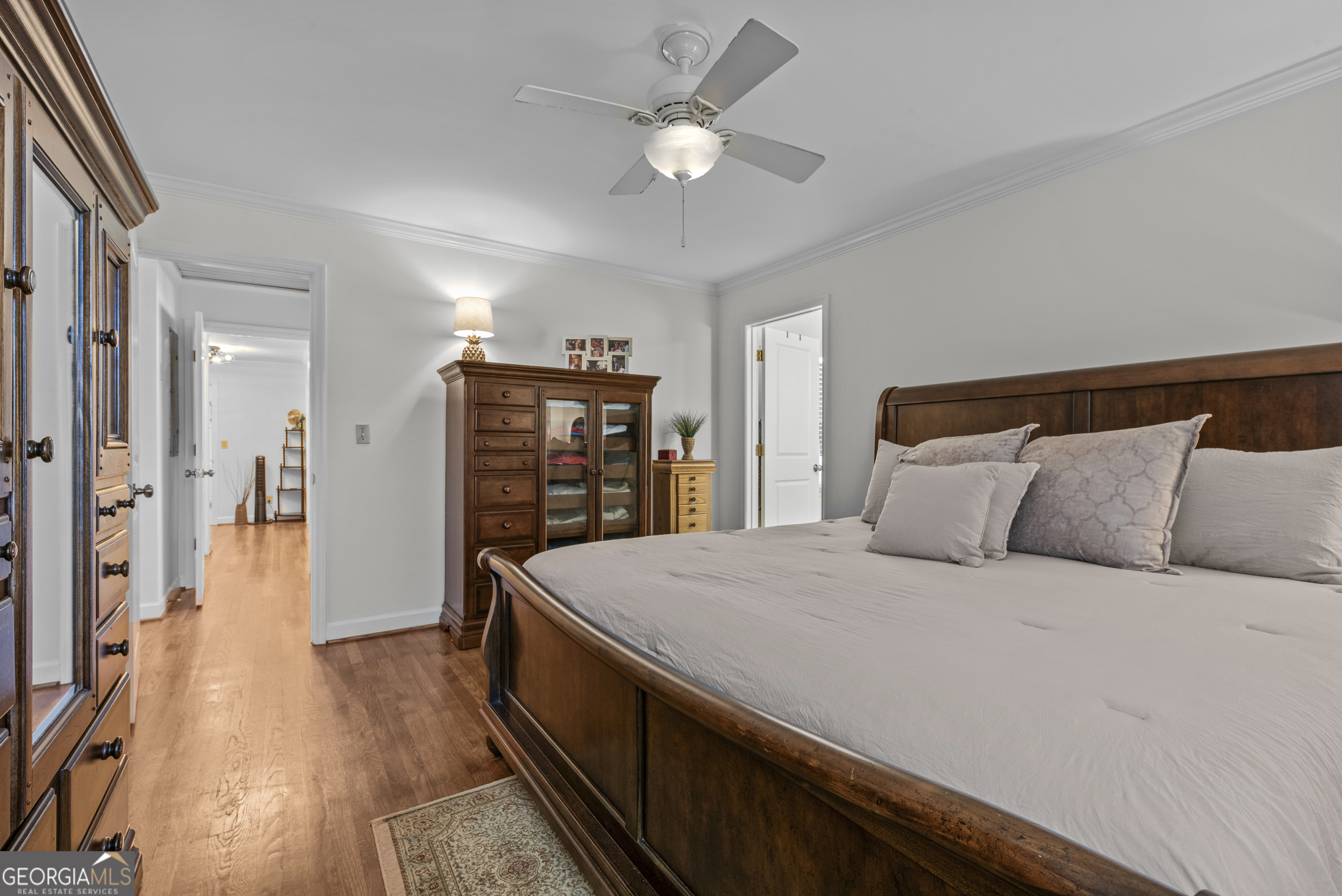 991 Old Post Road Madison, GA 30650 - Photo 34 of 61 a bedroom with a bed and a chandelier