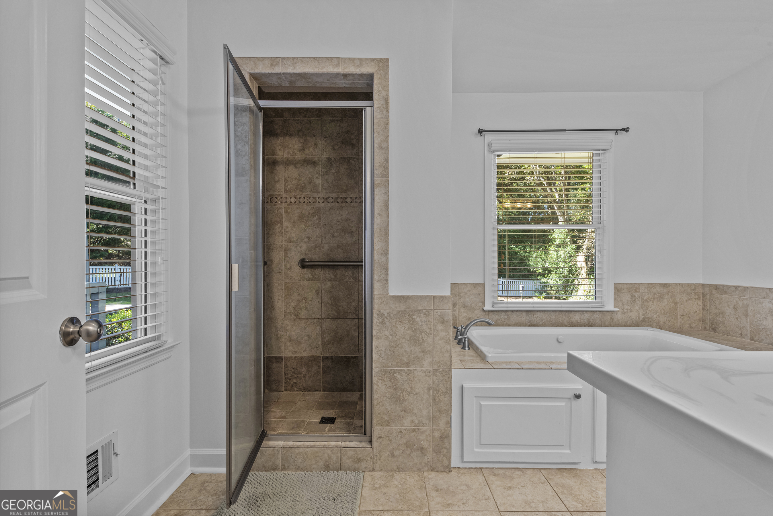 991 Old Post Road Madison, GA 30650 - Photo 35 of 61 a bathroom with a tub sink and window