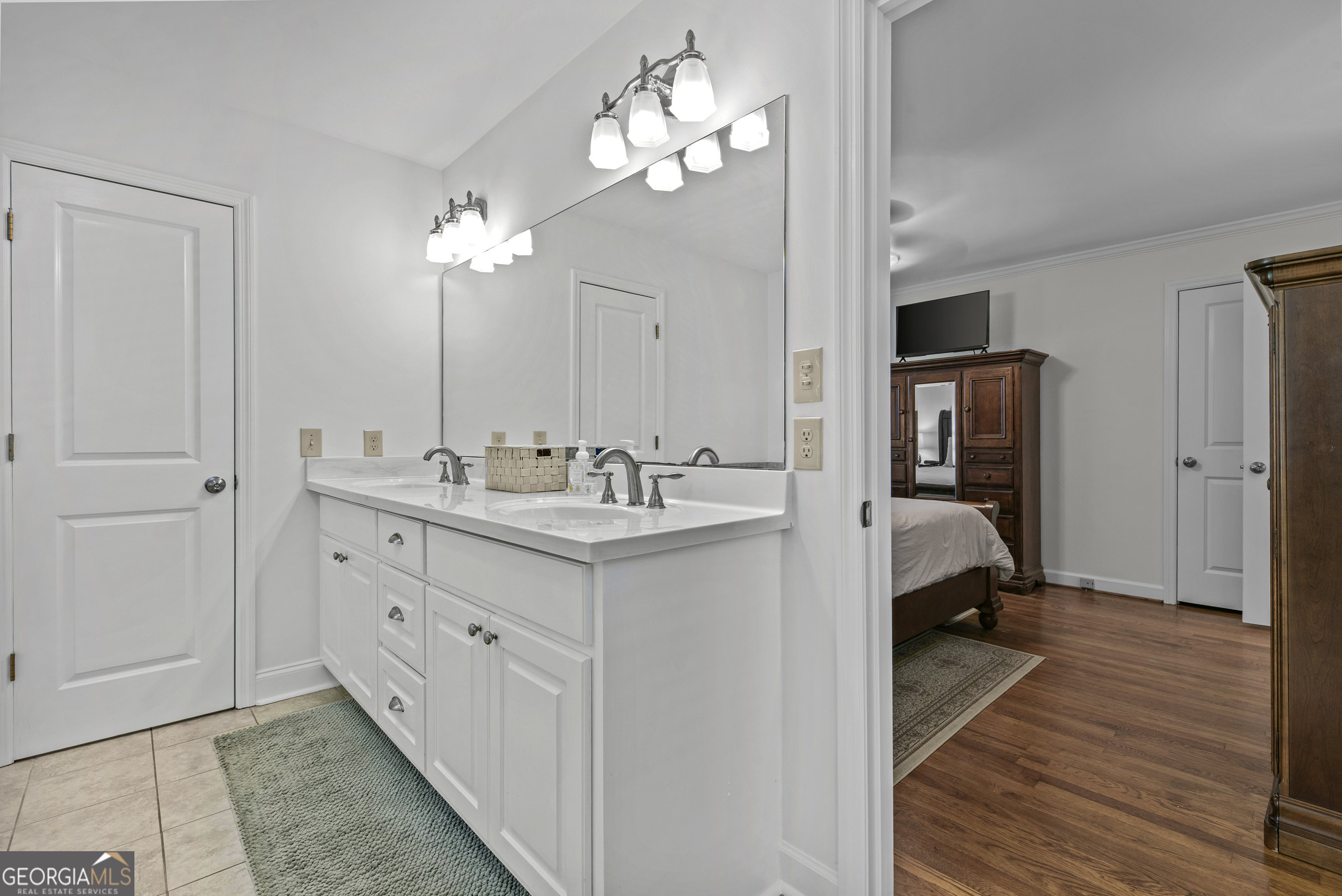 991 Old Post Road Madison, GA 30650 - Photo 36 of 61 a en suite bathroom with a double vanity sink a mirror and a shower