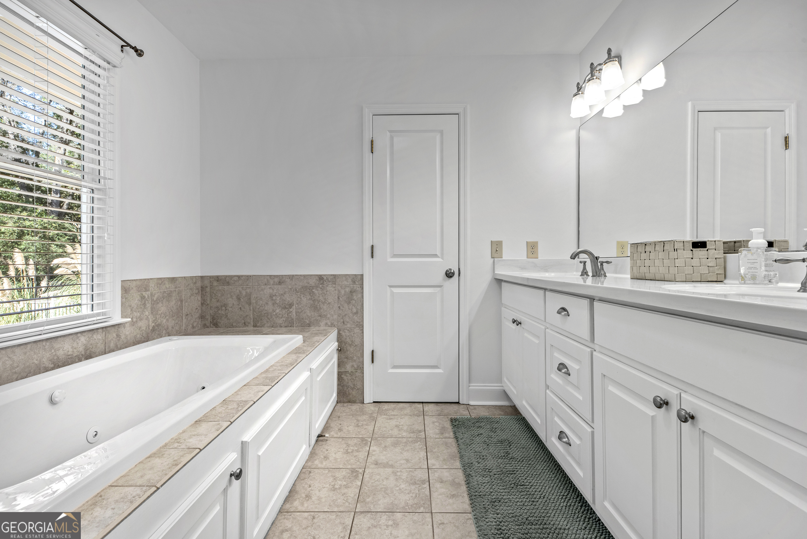 991 Old Post Road Madison, GA 30650 - Photo 37 of 61 a spacious bathroom with a tub sink and mirror