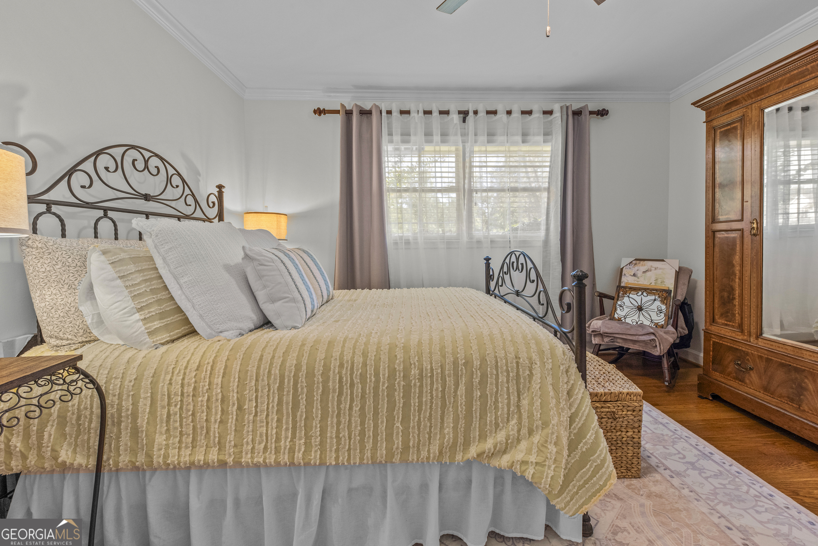 991 Old Post Road Madison, GA 30650 - Photo 42 of 61 a bedroom with a bed and wooden floor