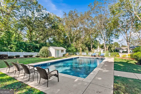 a view of a house with backyard and sitting area