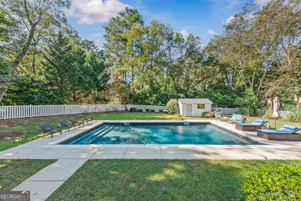 an aerial view of house with yard swimming pool and outdoor seating