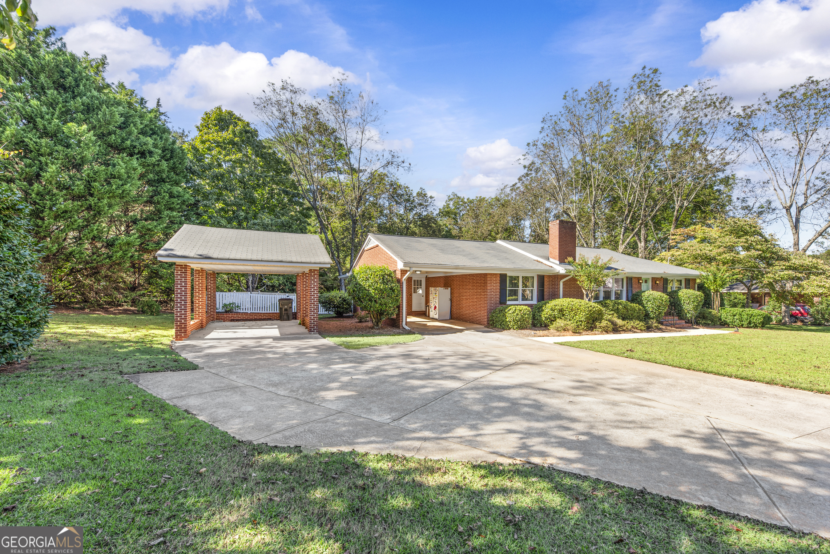 991 Old Post Road Madison, GA 30650 - Photo 51 of 61 a front view of a house with a garden and trees