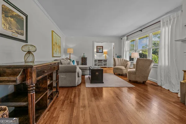 a living room with fireplace furniture and a wooden floor