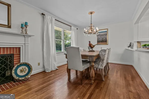 a kitchen with stainless steel appliances a stove a refrigerator cabinets and a dining table