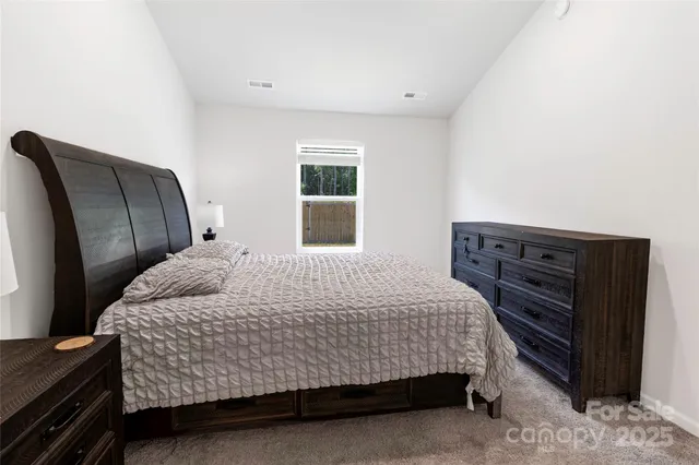a bedroom with a bed and dresser