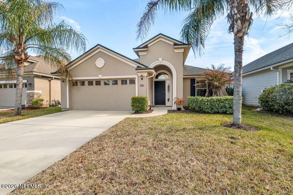 14042 Carson Court Jacksonville, FL 32224 - Photo 1 of 37 a front view of a house with a garden and trees