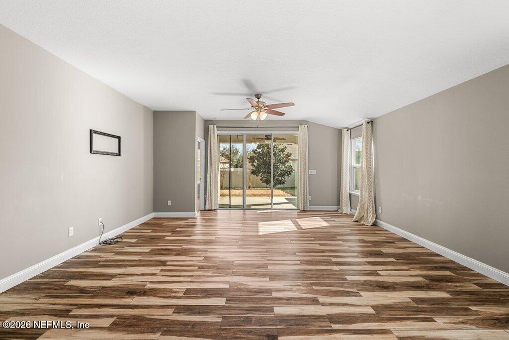 14042 Carson Court Jacksonville, FL 32224 - Photo 18 of 37 a view of an empty room with wooden floor and a window