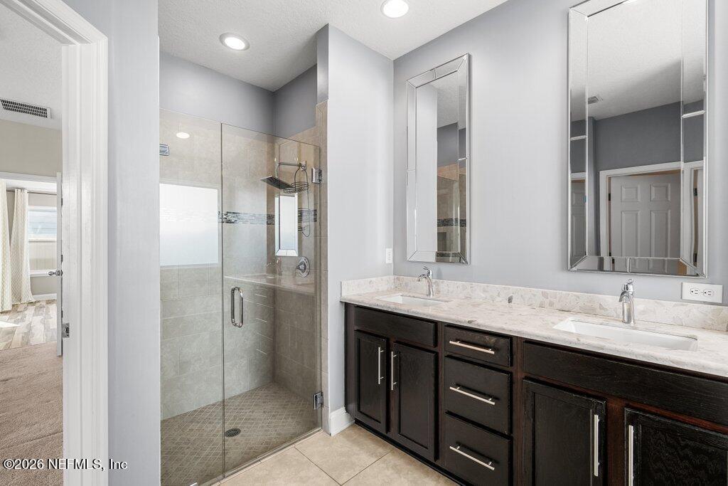 14042 Carson Court Jacksonville, FL 32224 - Photo 23 of 37 a bathroom with a granite countertop sink shower and a mirror