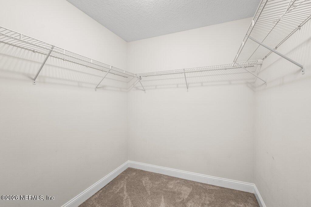 14042 Carson Court Jacksonville, FL 32224 - Photo 25 of 37 a view of a room with racks on the wall