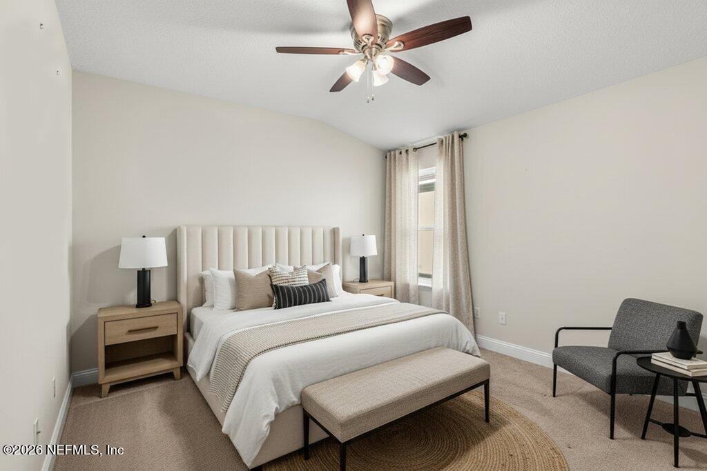 14042 Carson Court Jacksonville, FL 32224 - Photo 26 of 37 a bedroom with a bed and a chair