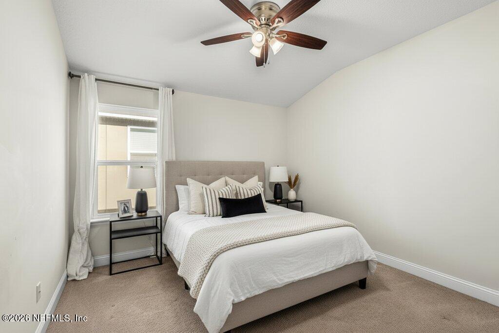 14042 Carson Court Jacksonville, FL 32224 - Photo 28 of 37 a bedroom with a bed and a chandelier
