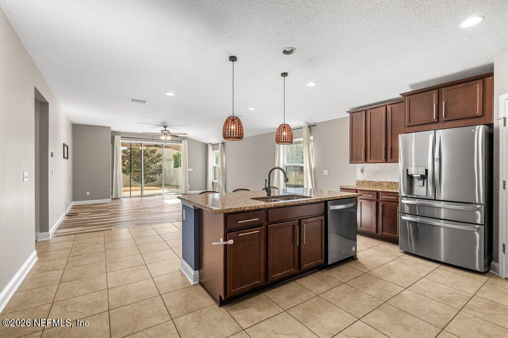 14042 Carson Court Jacksonville, FL 32224 - Photo 9 of 37 a kitchen with stainless steel appliances granite countertop a stove a sink and a refrigerator