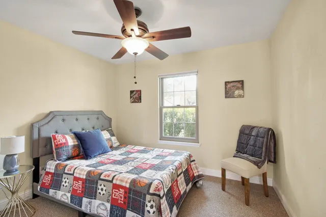 a bedroom with a bed and a chair