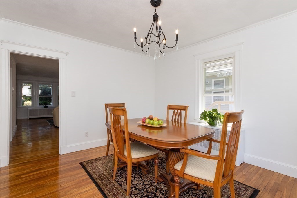 16 Libbey Street Boston, MA 02132 - Photo 17 of 41 a view of a dining room with furniture wooden floor and a chandelier