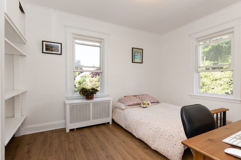 16 Libbey Street Boston, MA 02132 - Photo 22 of 41 a bedroom with a bed table chair and window