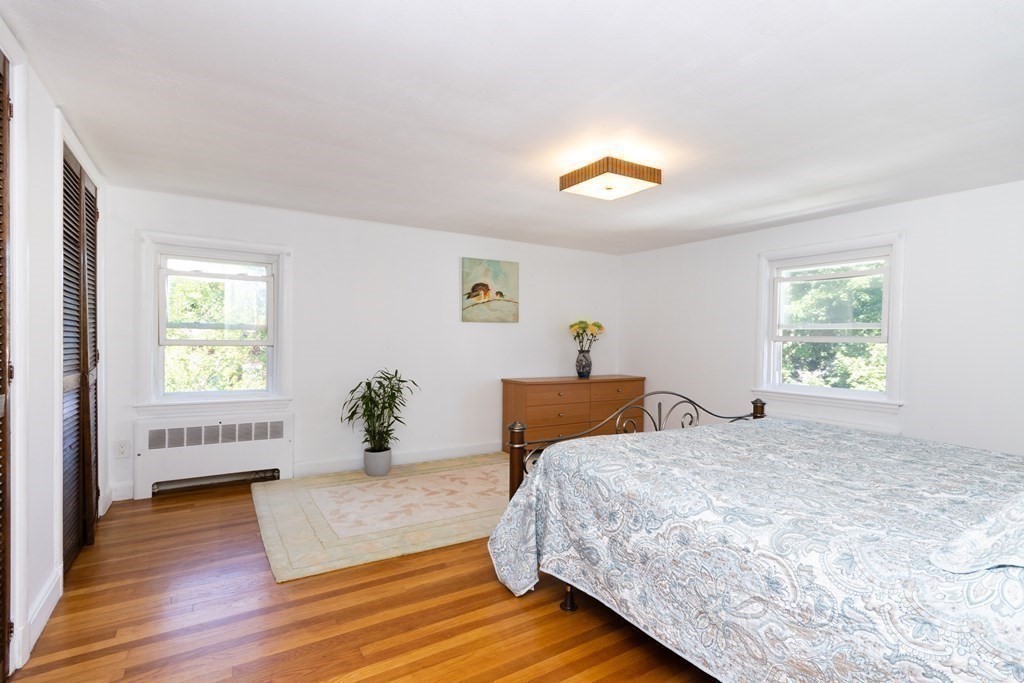 16 Libbey Street Boston, MA 02132 - Photo 26 of 41 a bedroom with a bed and wooden floor