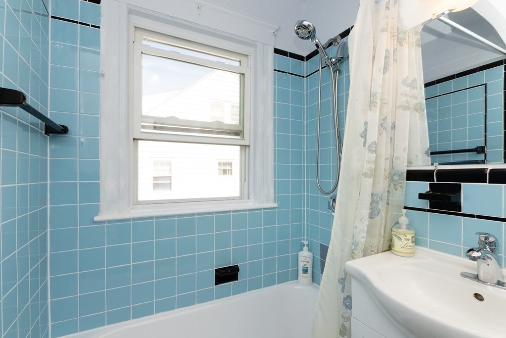 16 Libbey Street Boston, MA 02132 - Photo 29 of 41 a bathroom with a sink a toilet a window and shower