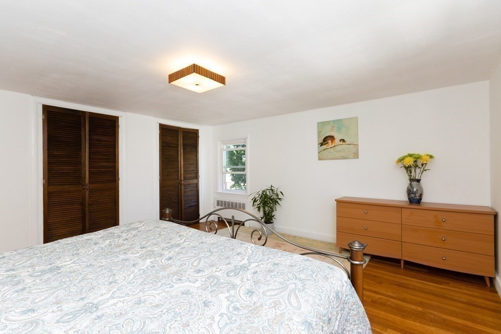 16 Libbey Street Boston, MA 02132 - Photo 32 of 41 a bedroom with a bed and a dresser