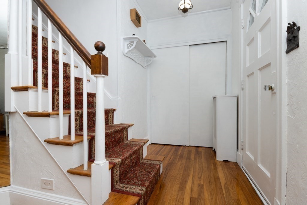 16 Libbey Street Boston, MA 02132 - Photo 6 of 41 a view of a livingroom with wooden floor and stairs