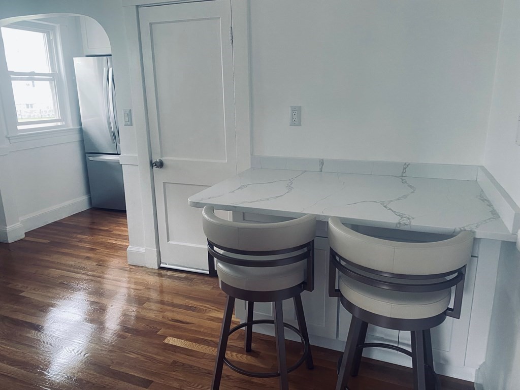 16 Libbey Street Boston, MA 02132 - Photo 9 of 41 a bathroom with a sink a chair a toilet and a mirror